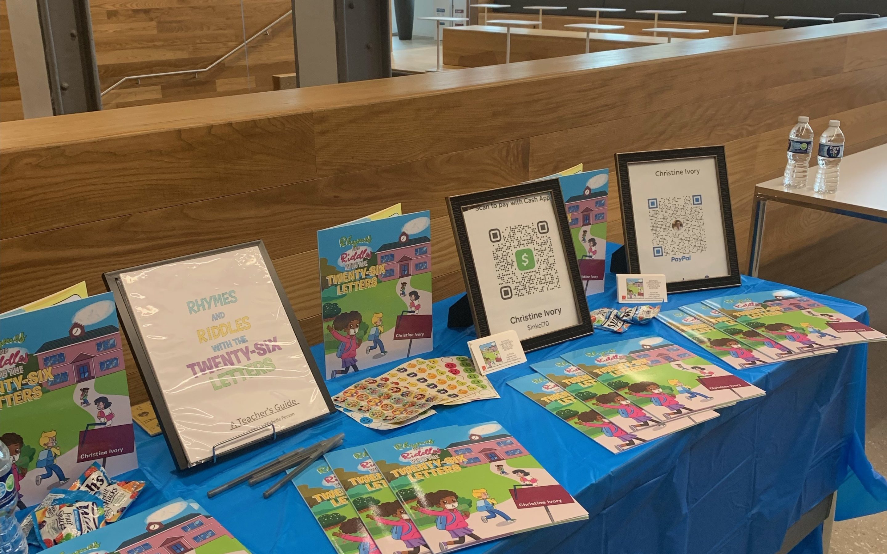 View of event table with Christine Ivory's book, Rhymes & Riddles with the Twenty-Six Letters