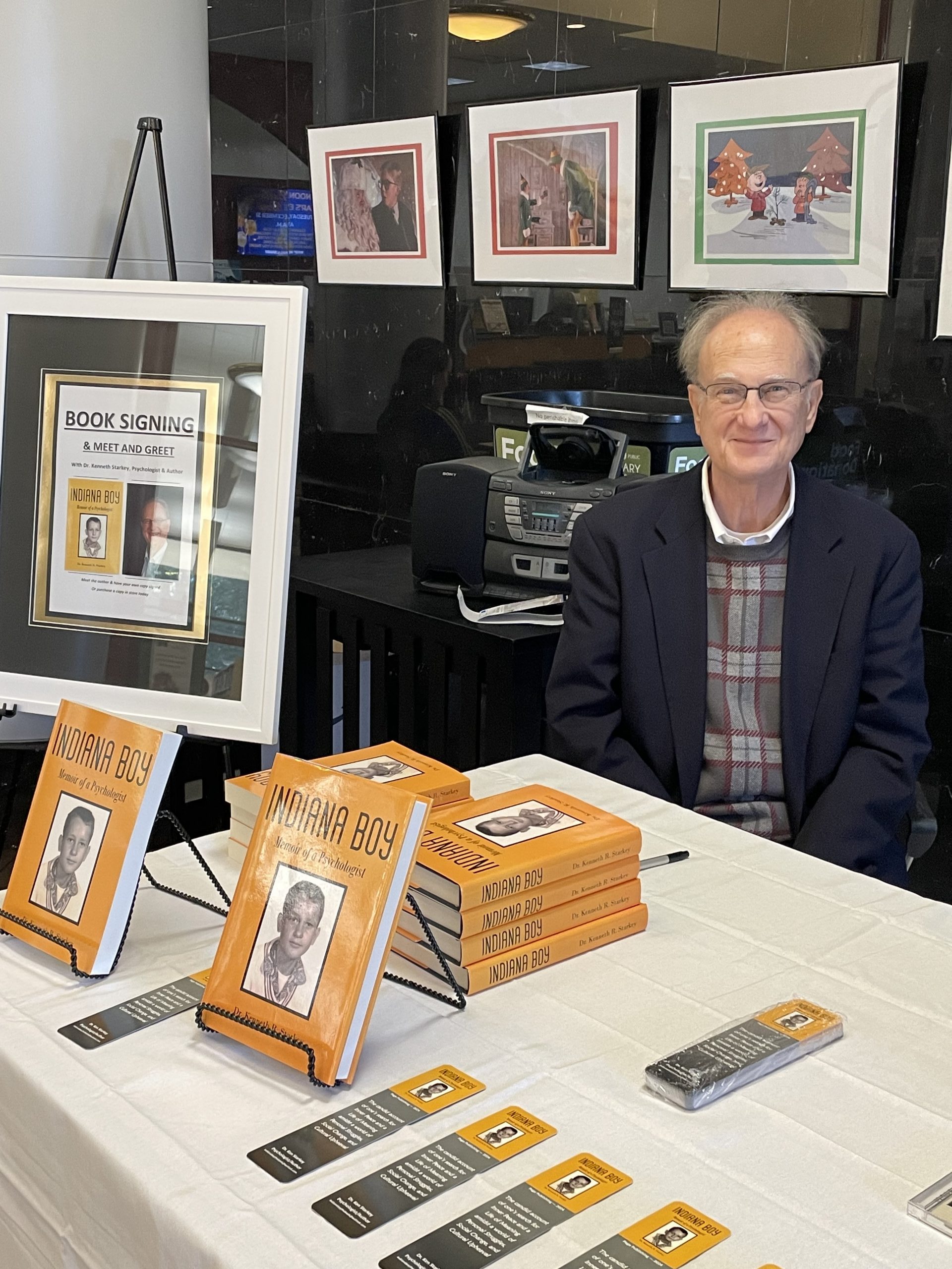 Photo of Ali Mazhin holding his book, The Running Journey