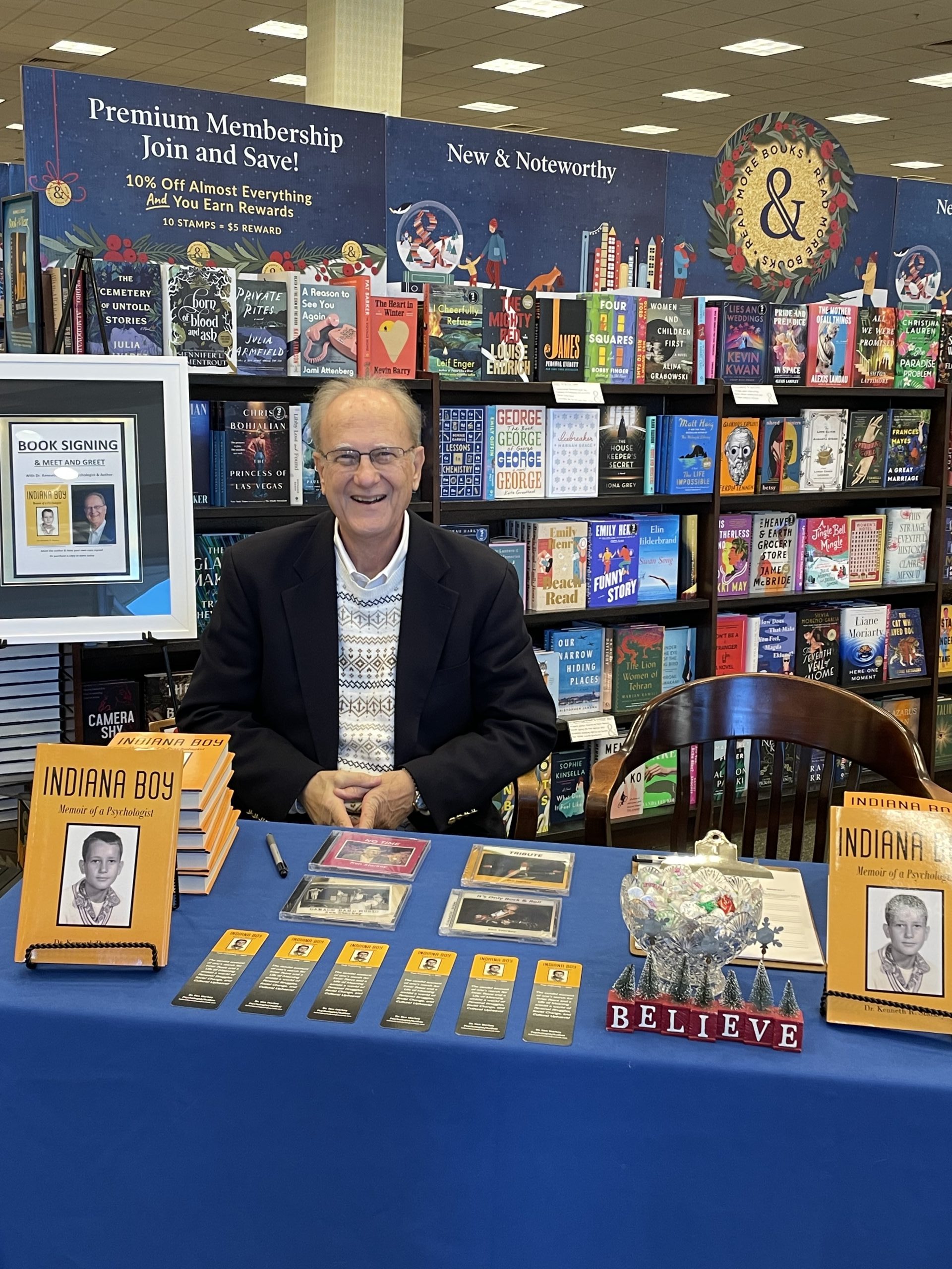 Photo of Ali Mazhin holding his book, The Running Journey