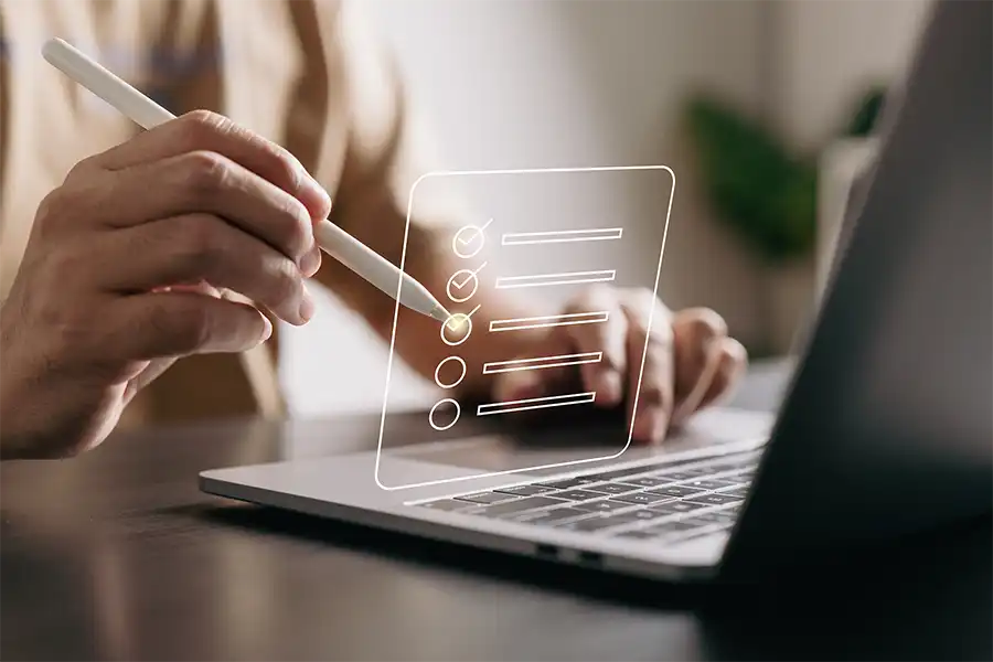 closeup image of a woman using a pen to check off a virtual checklist